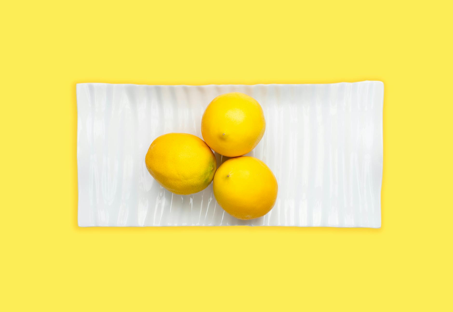 Fresh lemons on a white plate, symbolizing renewal and the return to something fresh and intentional
