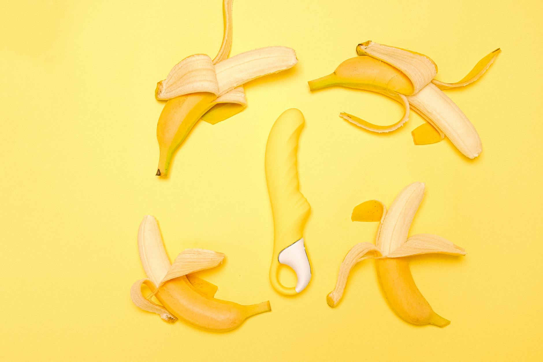 A yellow silicone lemon vibrator on a yellow background, symbolizing gentle clitoral stimulation
