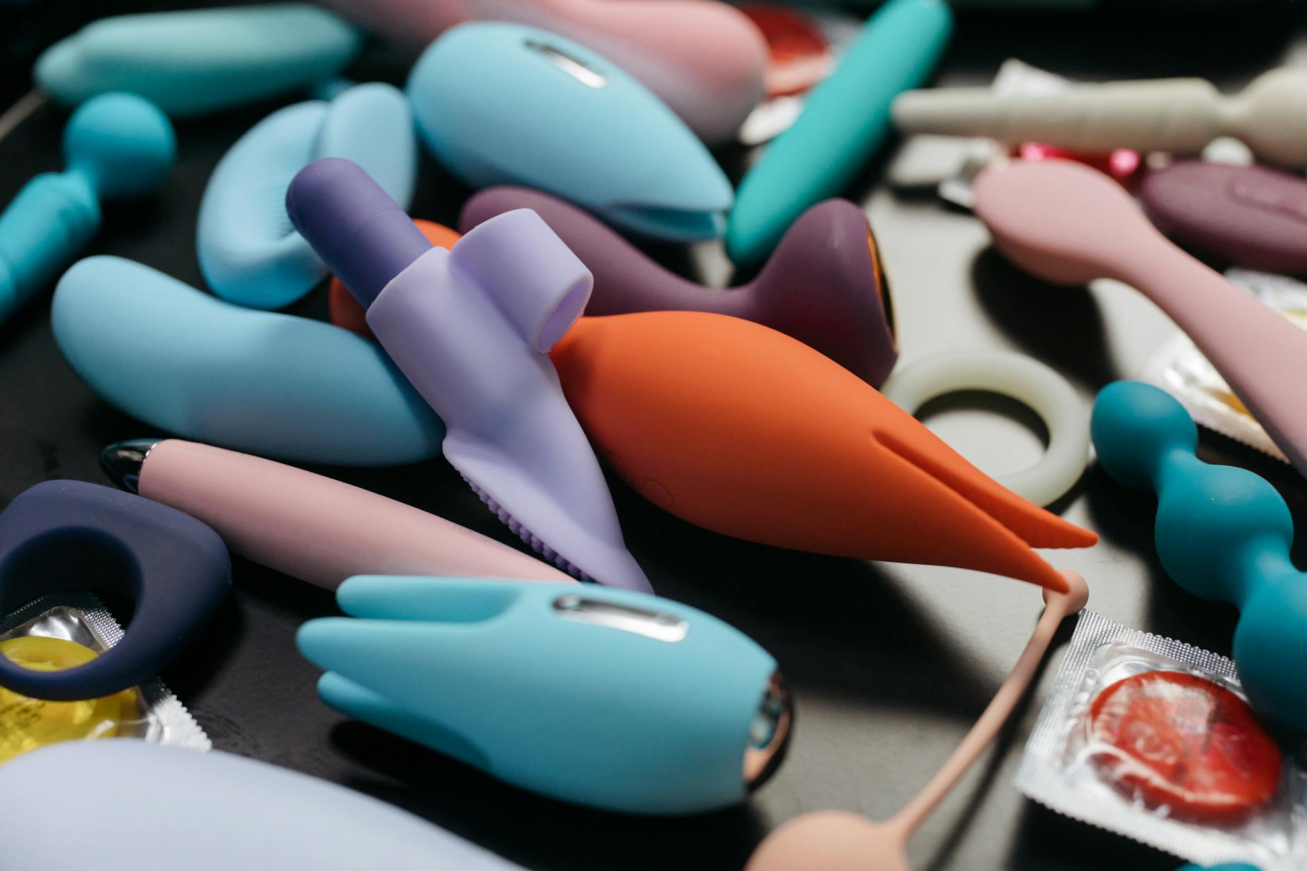 An array of vibrant adult toys including vibrators in a close-up view