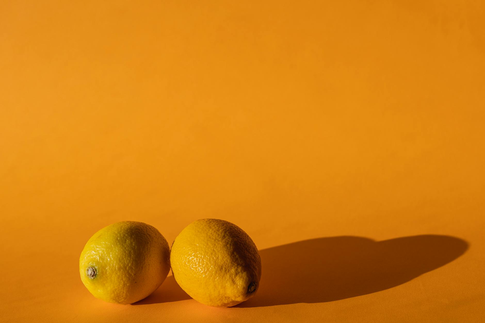 Bright yellow lemons arranged on a pastel background symbolizing renewed sexual wellness